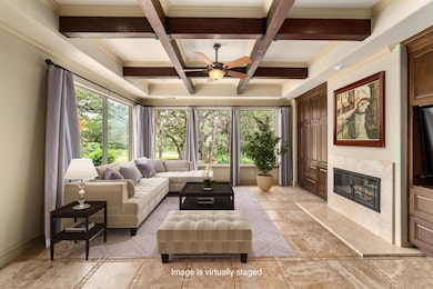 Living area featuring ceiling fan, beam ceiling, 