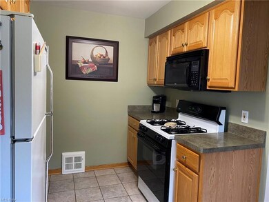 Oak cabinets, pull out shelves & ceramic tile floo