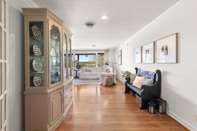 Living room with visible vents, baseboards, light