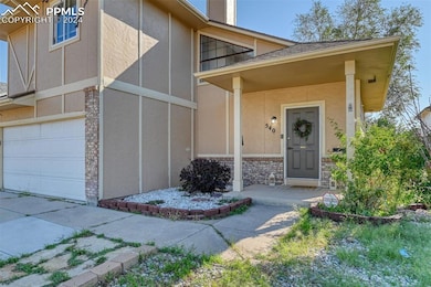 Doorway to property with a garage