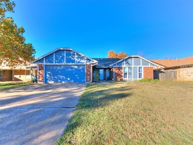 View of front of home with a front yard and a gara
