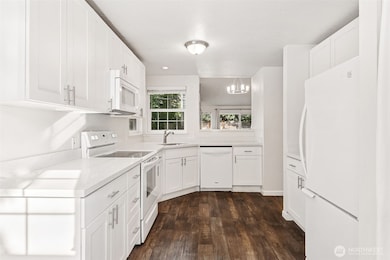 Stylish kitchen with ample cabinetry and quartz counters.