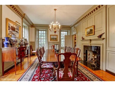 Spacious formal ding room with fireplace and butle