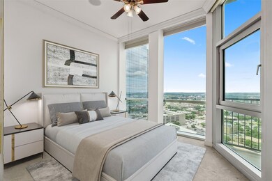 Carpeted bedroom featuring ceiling fan and access 