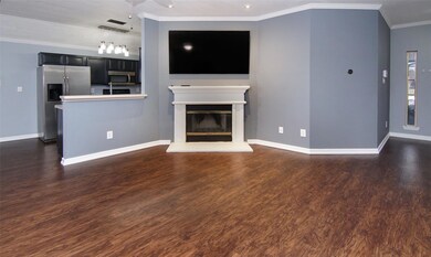 Unfurnished living room featuring crown molding an