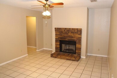 Unfurnished living room with a ceiling fan, a bri