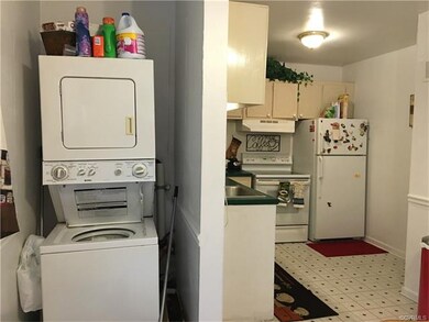 Washer/ dryer stack with kitchen nearby
