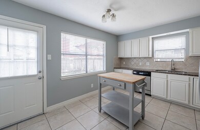 Kitchen offers multiple outdoor views and plenty o