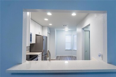 Kitchen opens to the den with space for bar stools