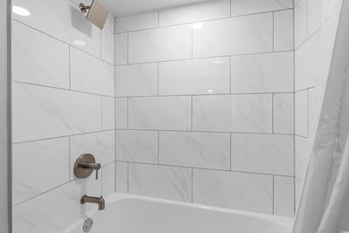 Room details with shower / tub combo