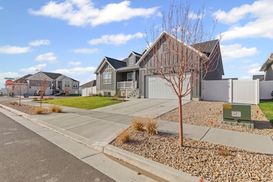 View of front facade with a gate, concrete driveway, a porch, board and batten siding, and a residential view