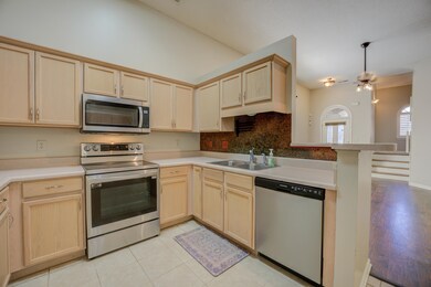 Kitchen featuring light brown cabinets, light tile
