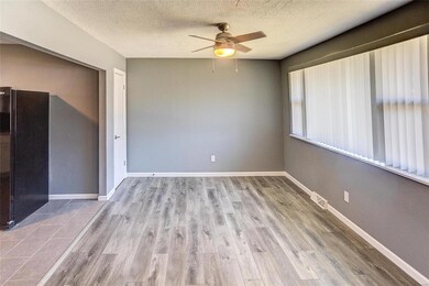 Spare room with a textured ceiling, light hardwood / wood-style floors, and ceiling fan