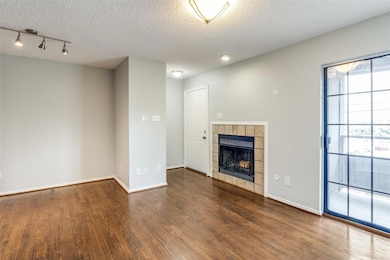 Unfurnished living room with baseboards, a tiled f