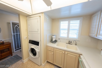 Washroom with stacked washer and clothes dryer and