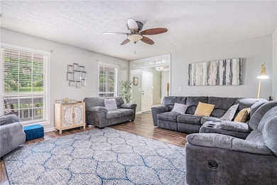 Living area with a textured ceiling, wood finished