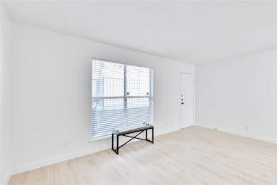 Spare room featuring wood finished floors and bas