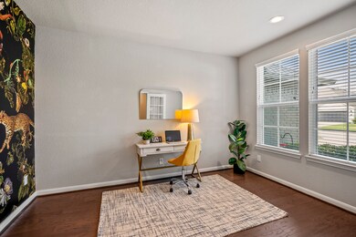 Situated at the front of the home, the large study overlooks the spacious front yard. Custom wallpaper adds character and a modern flair to the space.