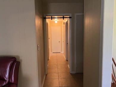 Hall featuring light tile patterned flooring