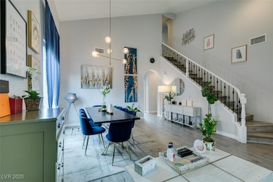 Living room featuring stairs, visible vents, wood