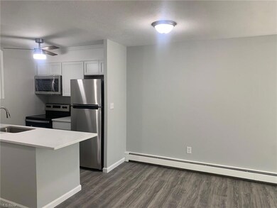 Kitchen with a textured ceiling, light countertops