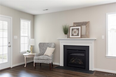 Living area with dark wood-type flooring, a firepl
