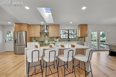 Kitchen featuring stainless steel fridge with ice 