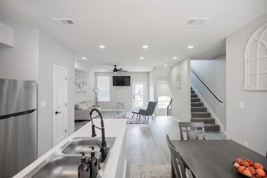 Kitchen with living area and stairs to the third f