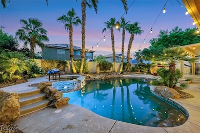View of pool with a pool with connected hot tub