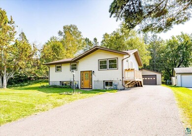 Raised ranch with an outdoor structure, a garage, 