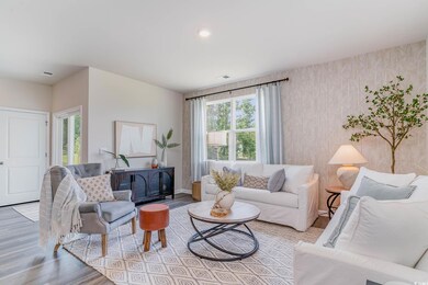 Living area with baseboards, visible vents, wood f
