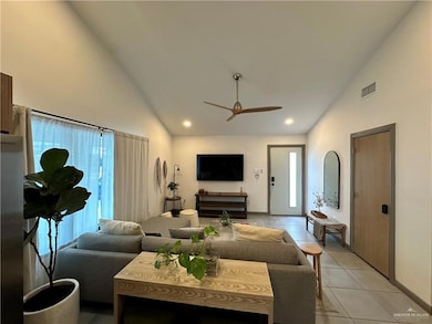 Living room featuring high vaulted ceiling, light tile patterned floors, a ceiling fan, and recessed lighting