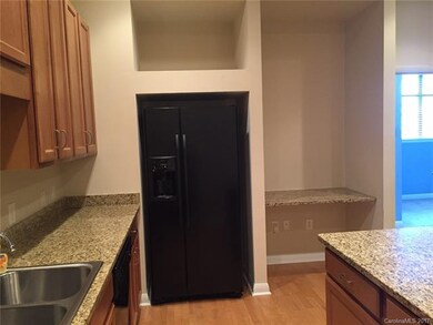 Black appliances are included:  refrigerator, dish