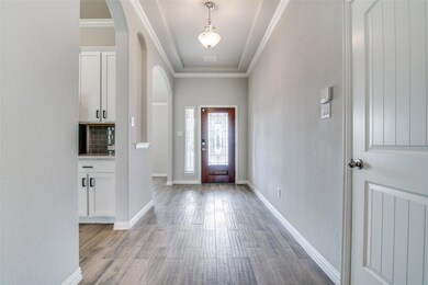 Foyer entrance featuring ornamental molding and light hardwood / wood-style floors