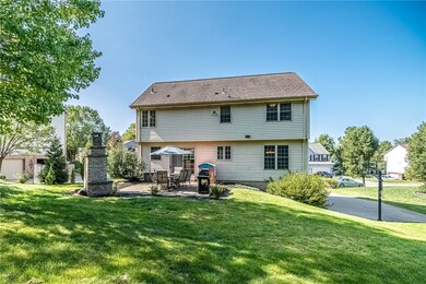 The level walk out patio leads to the tree lined backyard.
