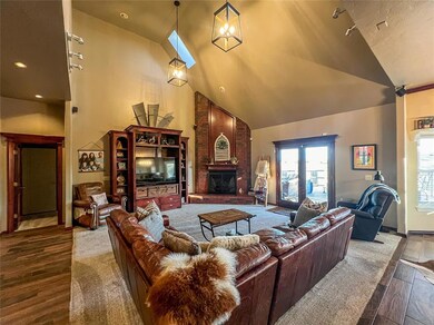 Living room with a fireplace, high vaulted ceiling