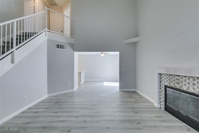 Unfurnished living room with visible vents, a towe