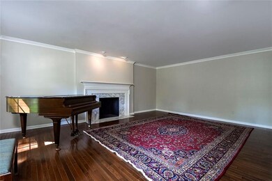 The Spacious Living Room with Crown Molding, Hardw