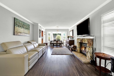 The home has a formal combination living an dining room for greeting guests and entertaining.  A fireplace with mantle centers the room.