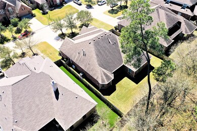 Another aerial view taken from the rear of the property.  The spacious living area is all located on one-level, yet there is still plenty of outdoor space in the front, rear and west side of the property.  The backyard could easily accommodate a future pool and garden.