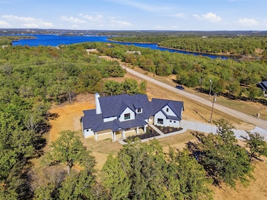 View of subject property with a forest and a large body of water