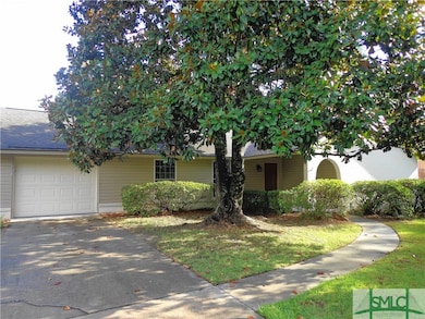 A Beautiful Magnolia Tree shades the Front Yard