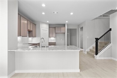 Another view of this spacious kitchen and staircas
