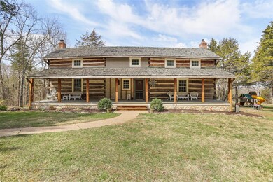 Relocated dogtrot log cabin with shake shingle roo