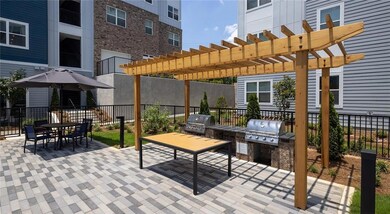 View of patio with an outdoor kitchen, a pergola, and outdoor dining space