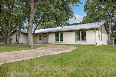 Ranch-style house featuring a front lawn, a metal