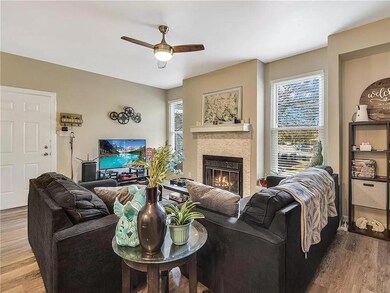 Living area with a ceiling fan, wood finished flo