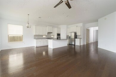 Unfurnished living room with a ceiling fan, dark 