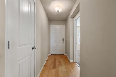 Doorway to outside with baseboards and hardwood / wood-style floors