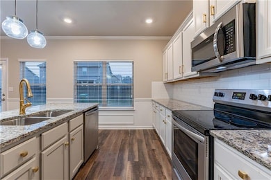 Kitchen with hanging light fixtures, stainless ste